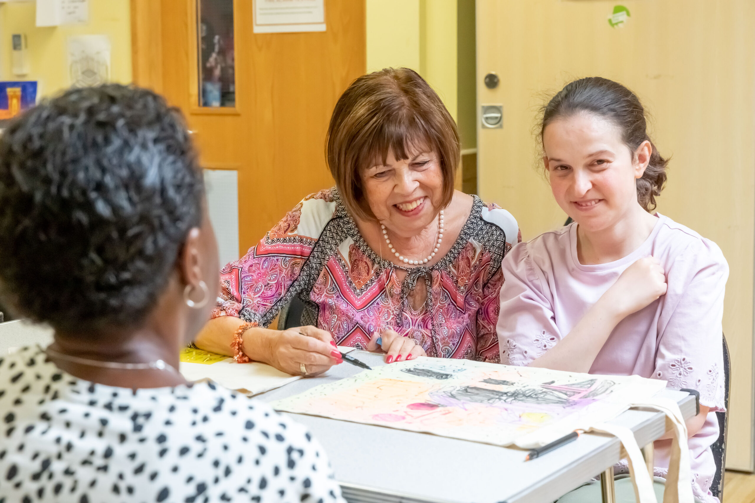 Volunteers supporting members at a community dance session