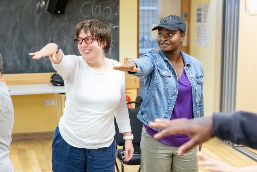 Two people stretching in an activity session