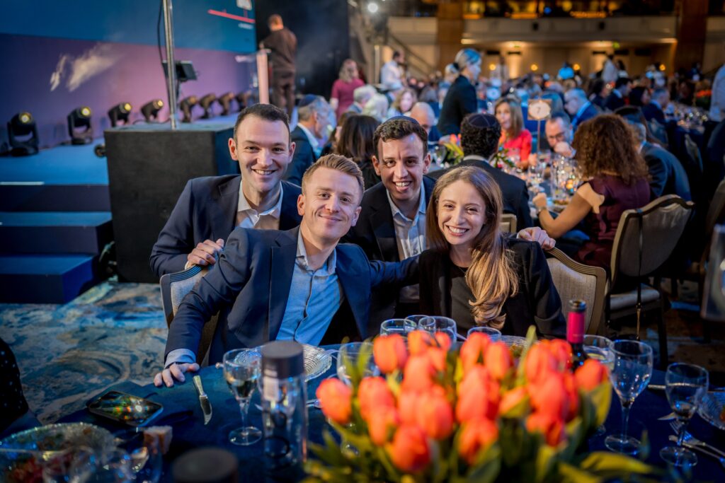 A group of young professionals sitting together at the Kisharon Langdon Dinner